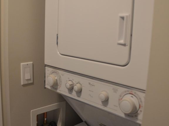 Stack washer and dryer in the bathroom nearest the kitchen
