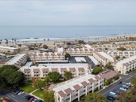 Unit is in this first back building, overlooking the garden space. Interior carport, and front parking. Clearly steps to the beach.