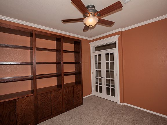 office with built-in shelves and french doors