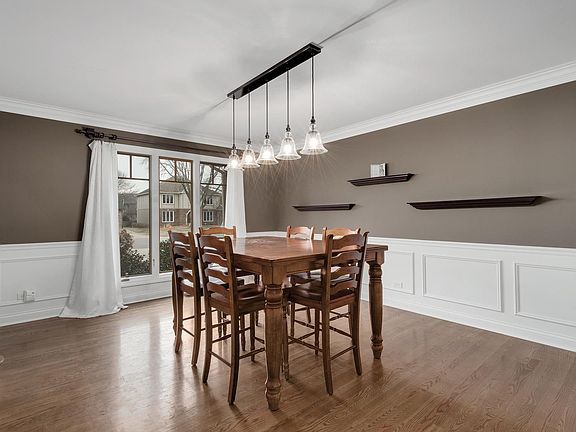 Wainscoting, Lovely Hardwood Floors & Updated Light Fixture