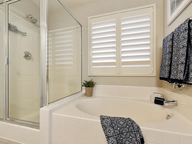 Primary bath with 2 sinks, large counter, shower, garden tub and walk in closet