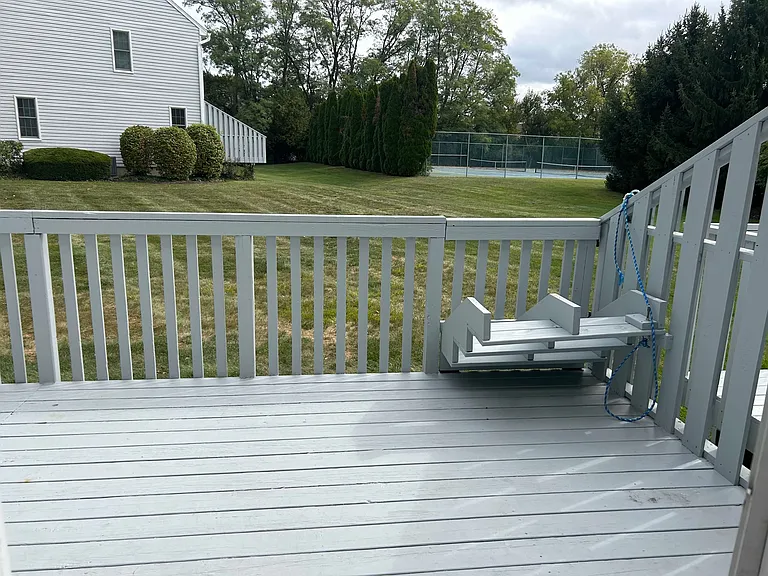 Retractable stairs on deck. View of community tennis courts in background