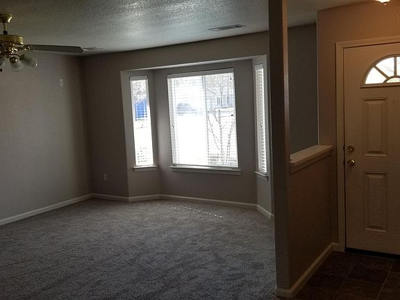 Bay window of the living room, surround wiring L and R up high on the walls, wagon wheel door with deadbolt and peep hole.