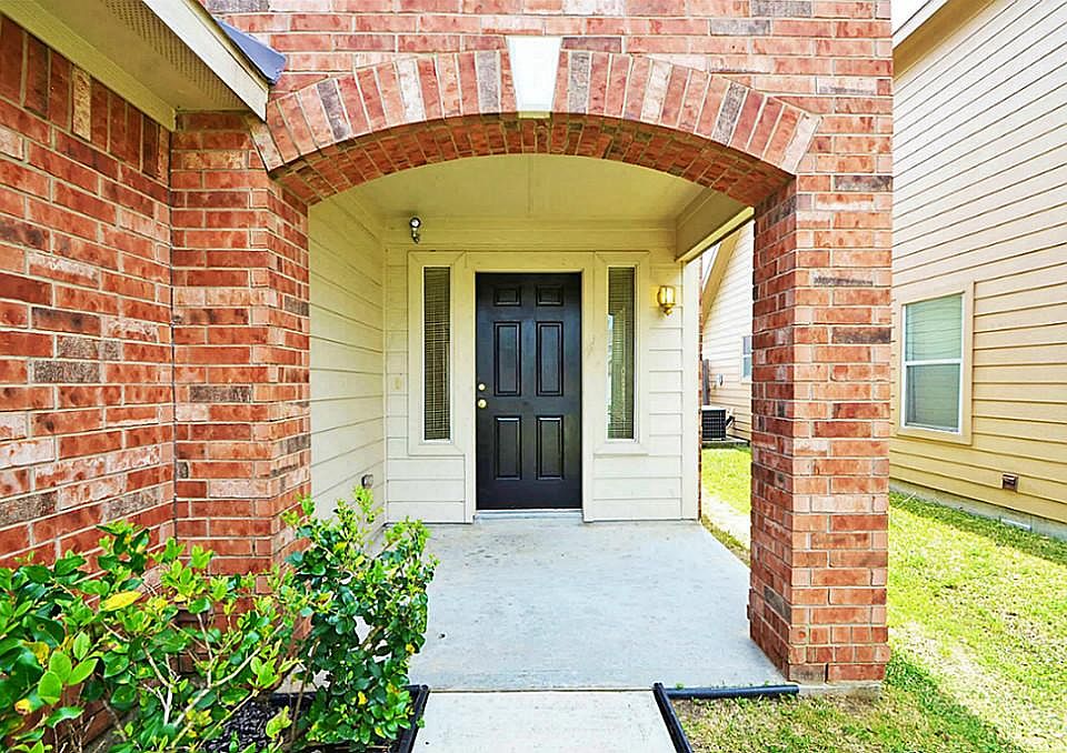 Covered porch to your new home with beautiful brick finishes.