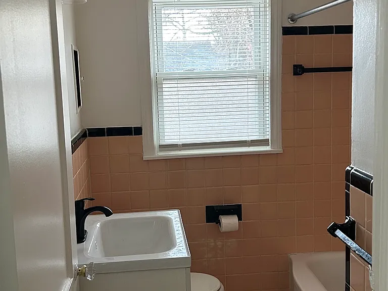 Clean, well-maintained bathroom with classic tile and updated fixtures.