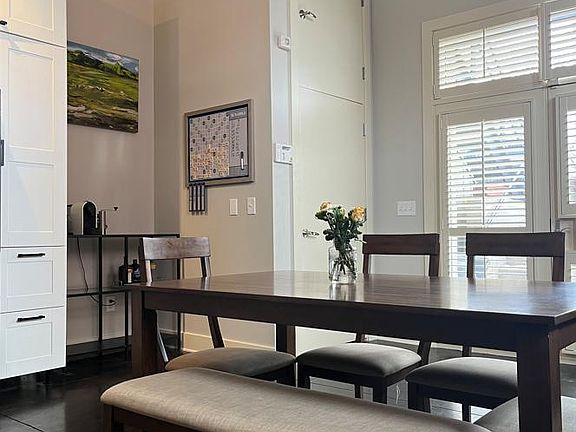 Double doors to the parking lot and outdoor space on the right. The door to the left is to the utilities and laundry closet.