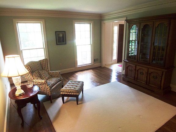 Elegant living room with hardwood floors and floor-to-ceiling windows