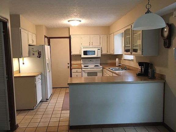 Kitchen features new tile floor and hardware.