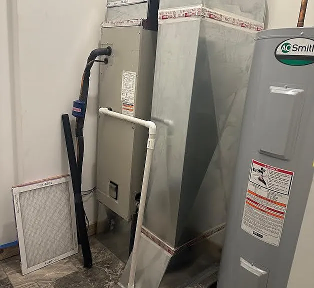 Mechanical room off garage with electric furnace/heat pump & electric 50gal water heater