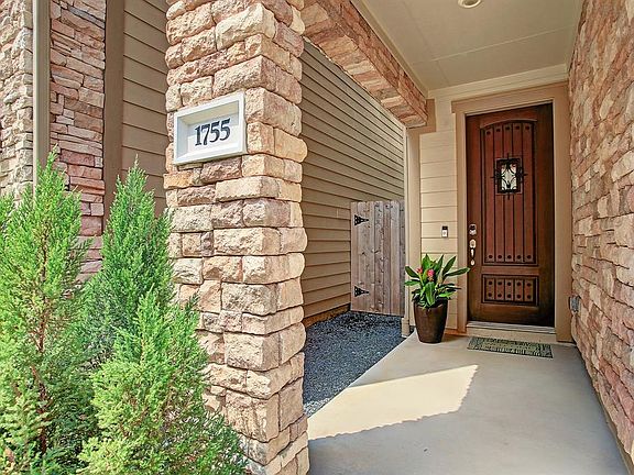The rock detail goes around into patio and helps make the front door the focal point. There is a ring doorbell and combination Schlage lock on the font door.