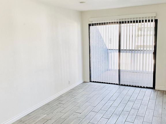 Living room facing sliding glass door leading to balcony.