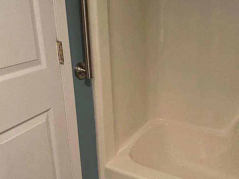 Stainless Steel grab bar for ease in navigating tub shower.
