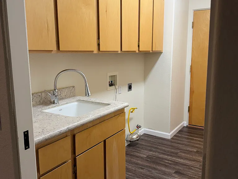 Laundry room with storage, sink, and washer and dryer hookups
