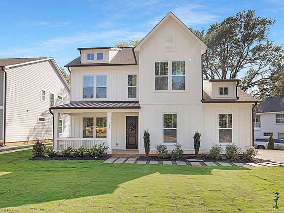 A large white house with a lot of windows is for sale.