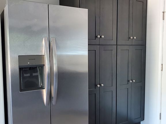 Pantry cabinets and fridge/freezer with ice maker