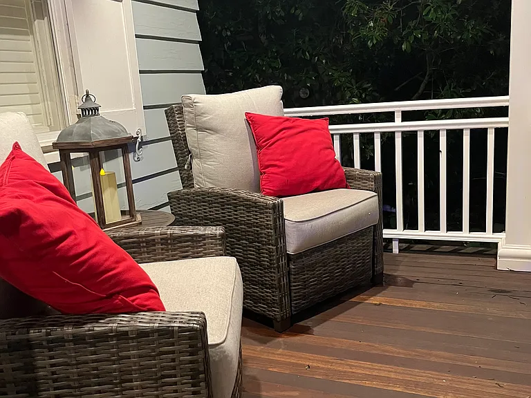There are lots of outdoor entertainment spaces. Front porch with lounge furniture and dining table for four.