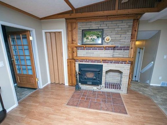 A view of the front entry way welcoming you to the living room, dining room and hallway to all three of the main floor bedrooms.