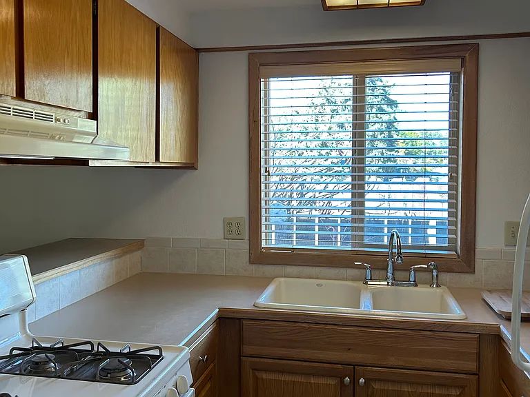 Kitchen with a gas stove and refrigerator.