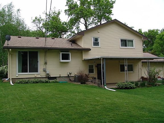 Back of home showing covered patio and sliding rear door from dining room