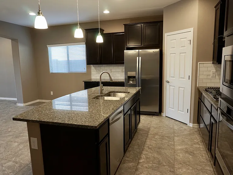Kitchen island with dishwasher and sink.