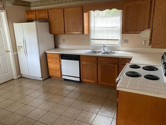 Alternate Kitchen View. Kitchen has Exterior Door and connects to Dining Room, Living Room, and Laundry Room.
