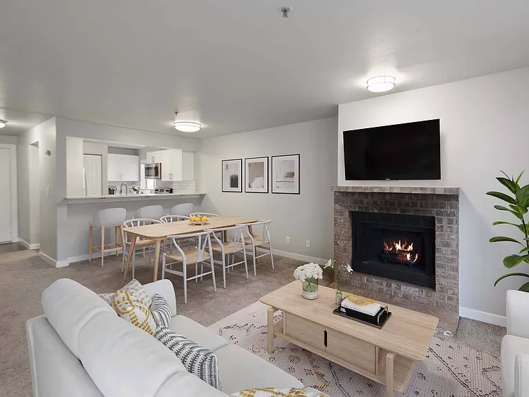 Enjoy an open-concept living room that flows effortlessly into the kitchen, creating a warm and connected space for everyday living