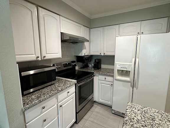 Kitchen + stainless steel electric stove + refrigerator + microwave