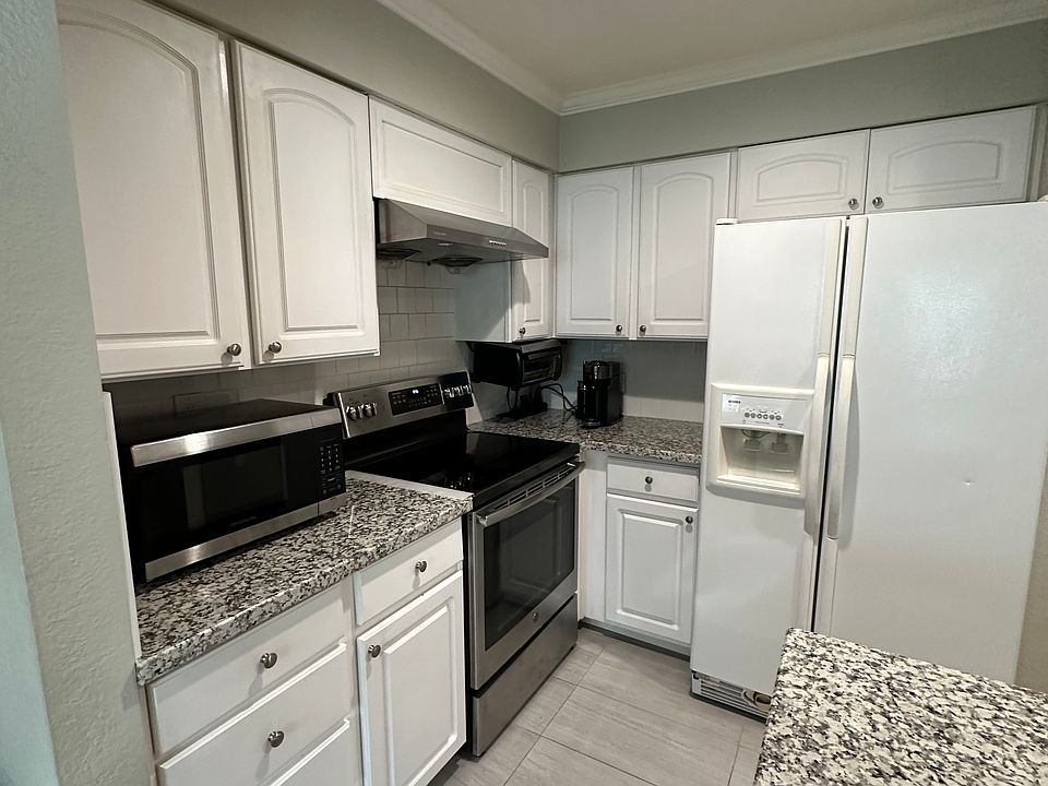 Kitchen + stainless steel electric stove + refrigerator + microwave