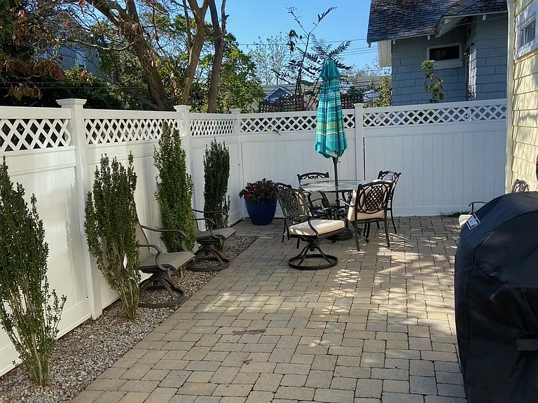Small back yard with patio and grill.