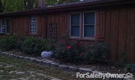 Front of home with fieldstone fireplace