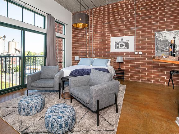 Queen size bed, 2 night stands and lounge seating for two.