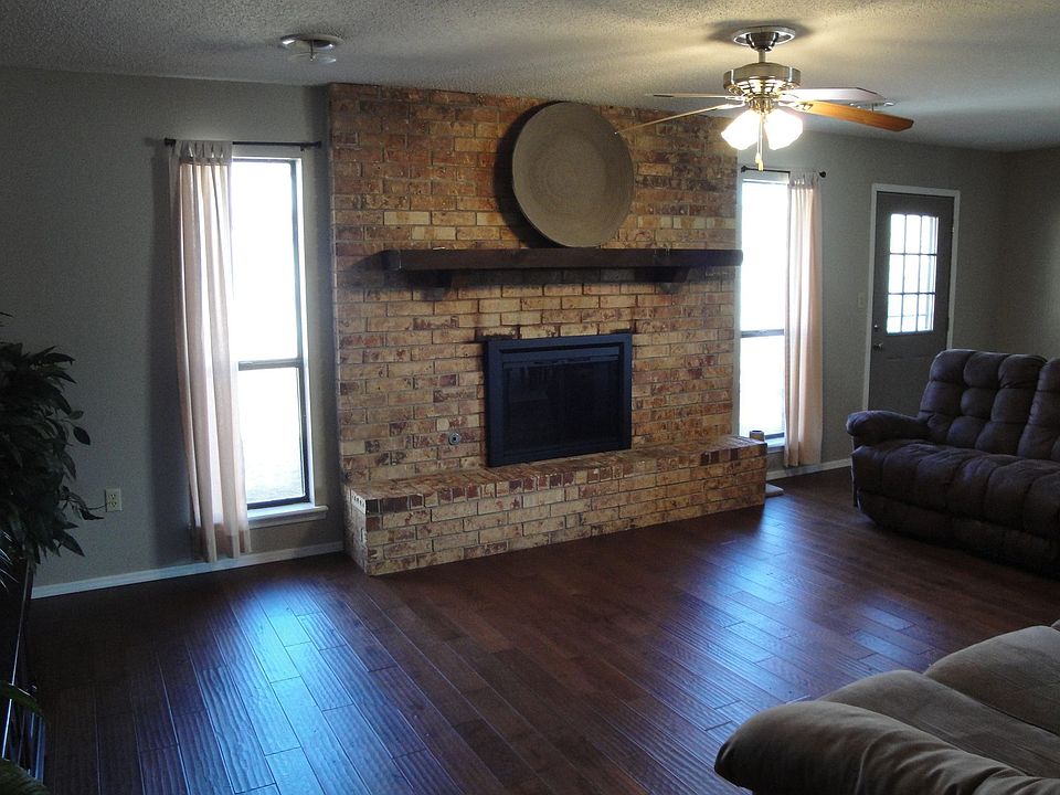 Gleaming, new hardwood floors and woodburingin F/P create a cozy family room
