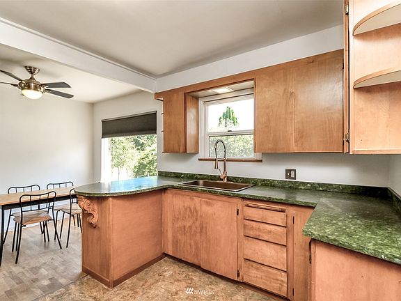Warm wood cabinetry in kitchen frames the natural views you get into the backyard!>