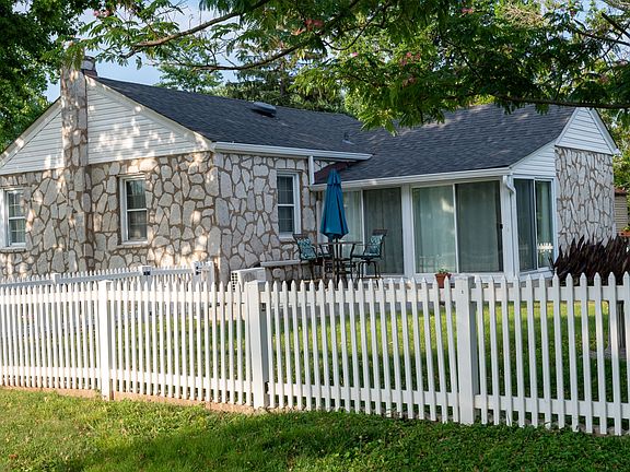 Fenced in yard with raised concrete patio area