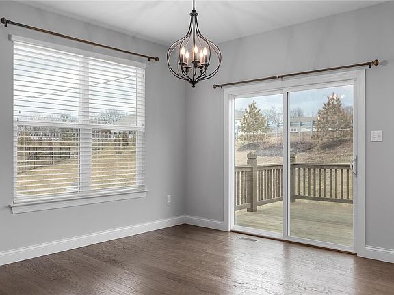 Nice breakfast area with decorative lighting, beautiful wood flooring and walks out to the deck.