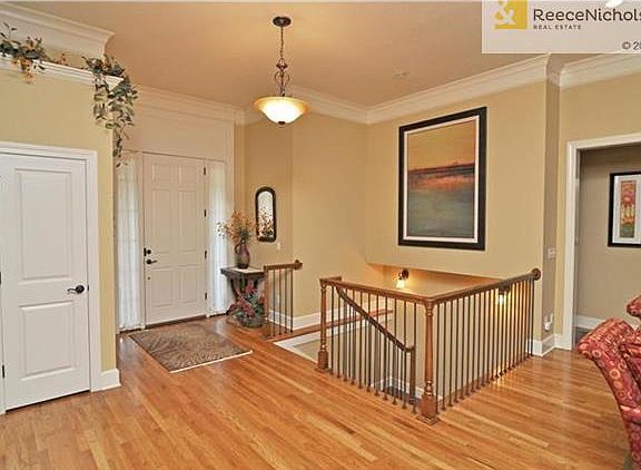 Note the rich moldings, zero entry front and garage doors, iron spindles and gorgeous hardwoods