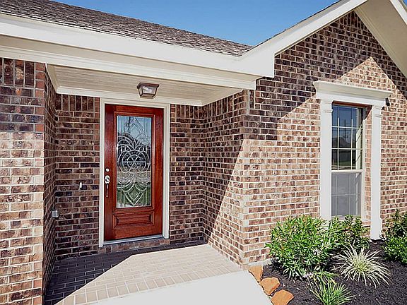 Exterior entry with an etched glass, triple pane front door.