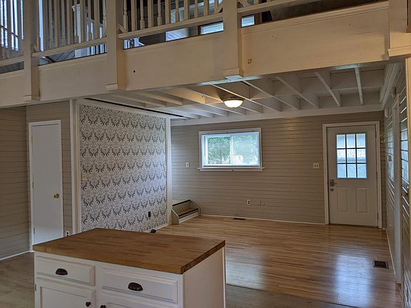 Livingroom with view of entry and upstairs loft