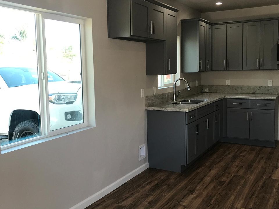 Refrigerator goes under the last gray cabinet on top.
