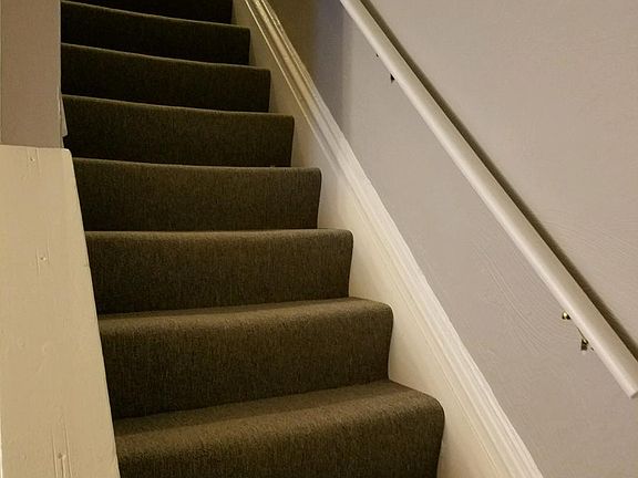 new carpeted steps leading to 2nd floor