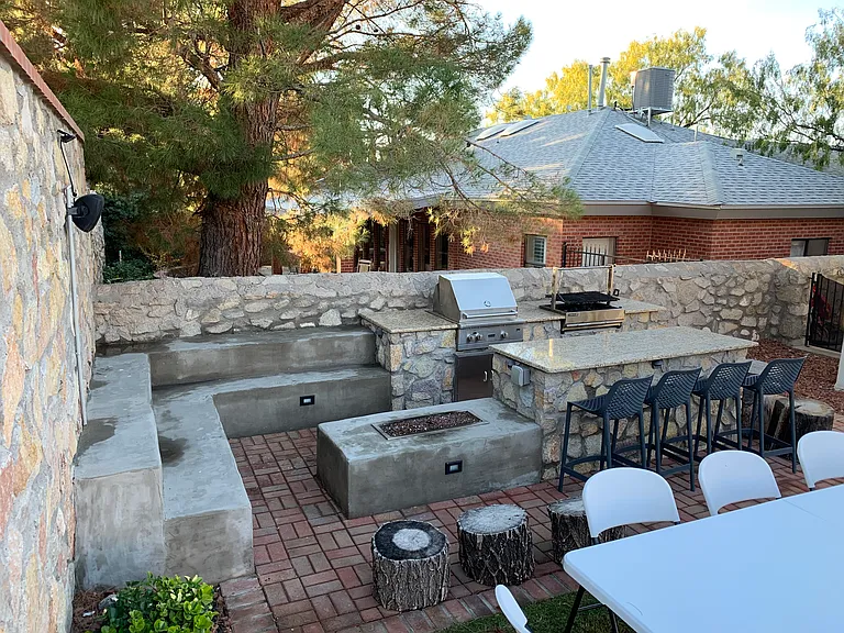 Gas and charcoal grills, granite counters and gas firepit with seating area