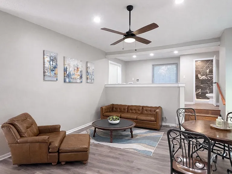 Living room with glass sliding door into backyard - looking into dining/ kitchen