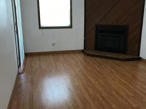 Living room with gas fireplace and access to patio
Storage area off of patio
