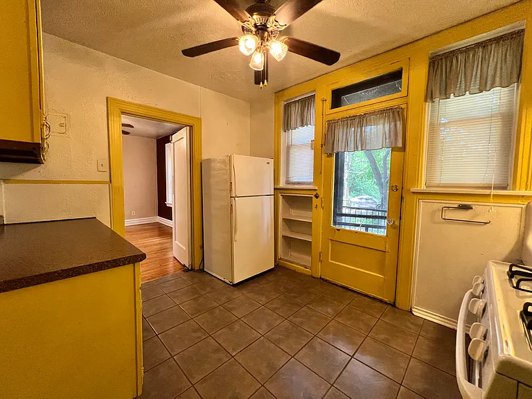 This kitchen features the original iron sink, plenty of natural light, and lots of storage space.