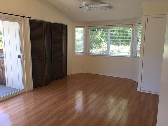 Family room that goes to deck. Laundry behind doors. All just painted white.
