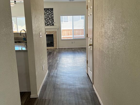 Entrance has high ceilings. Kitchen, powder room, and laundry room to the left and living and dining to the front
