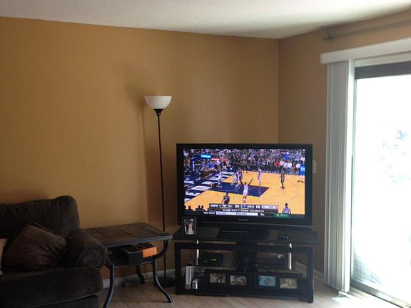 Living room with coat closet and sliding glass door to front