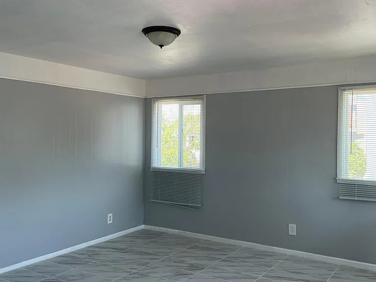 Fully remodeled living room tons of sunlight. View from kitchen.