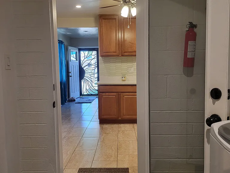 View from laundry room to kitchen, living room areas