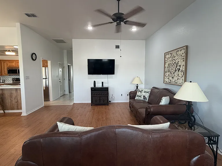 Open concept living area. Furniture pictured included with the lease.